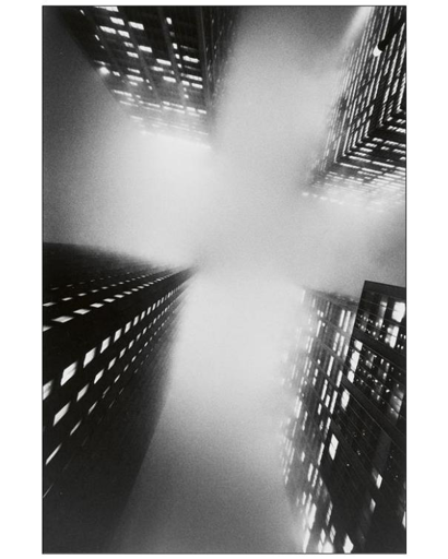 BW view from below of four skyscrapes in the fog.