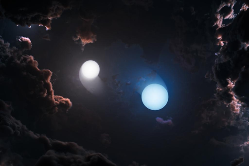 Rappresentazione artistica di due giovani stelle che orbitano l’una attorno all’altra all’interno del complesso di formazione stellare di Orione, ricco di polvere. Poiché nubi di gas e polveri nascondono questi sistemi alle lunghezze d’onda visibili e infrarosse, gli astronomi hanno utilizzato il Very Long Baseline Array della National Science Foundation (NSF VLBA) per osservarli nella luce radio e misurarne direttamente il moto orbitale e le masse.