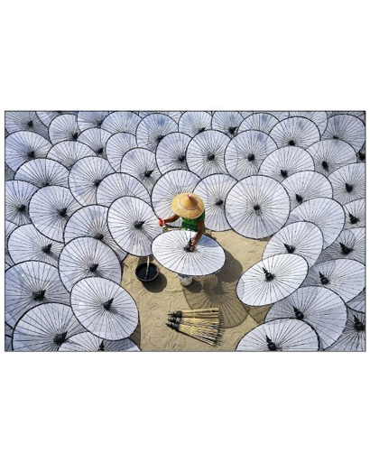A malaysian woman wearing hat among many white umbrellas.