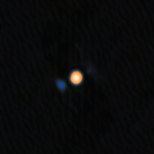 Un’immagine di Betelgeuse, la stella giallo-rossa, e della firma del suo compagno vicino, l’oggetto blu tenue.
