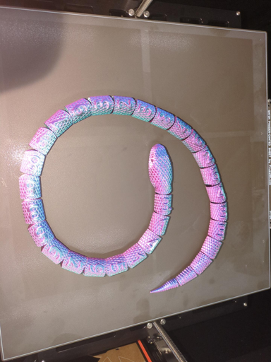 A 3d printed snake with the first 25 digits of pi on it.